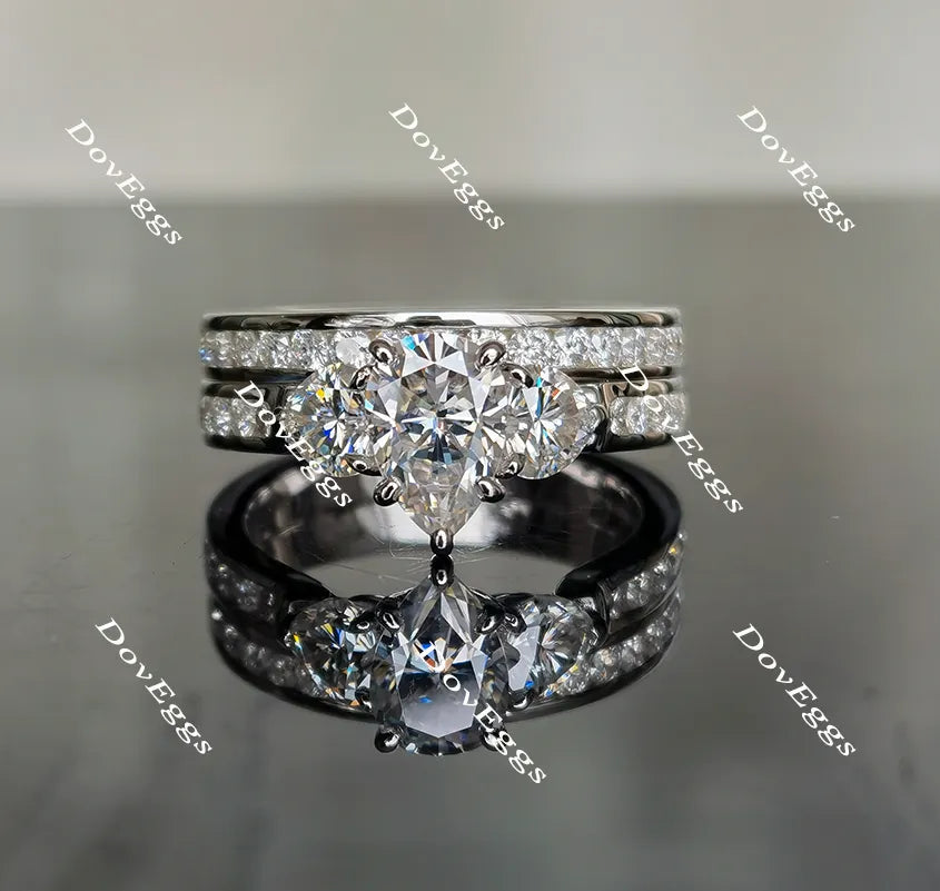 The Kiera Alaina pear half eternity channel set three stones moissanite engagement ring